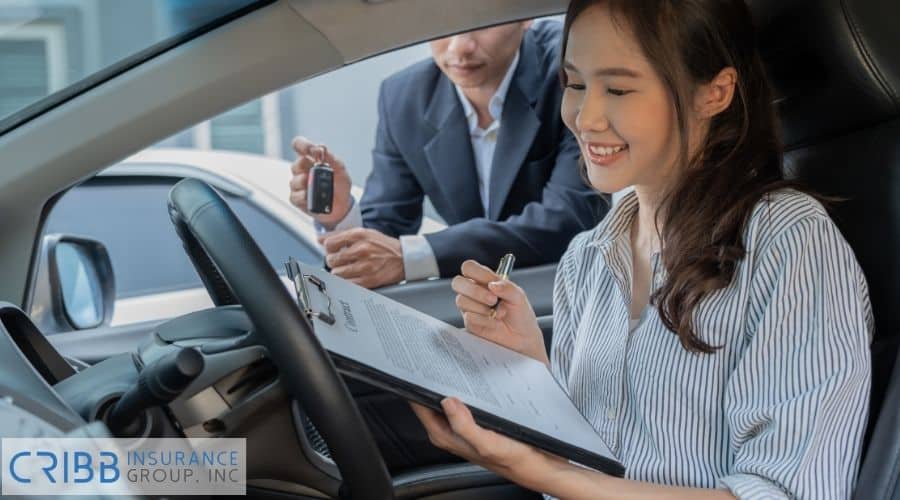 international driver holding license near a car